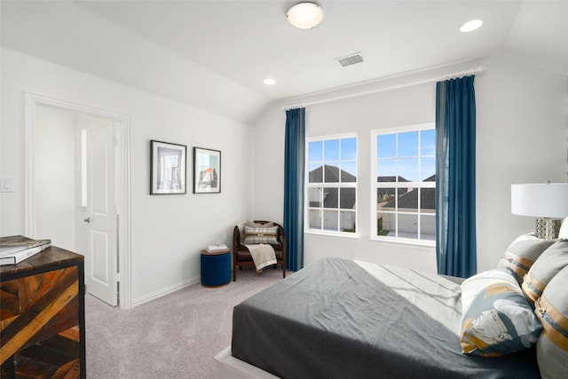 carpeted bedroom with vaulted ceiling