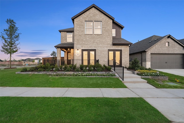 view of front facade featuring a garage and a lawn