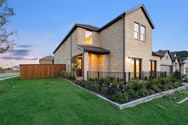 property exterior at dusk with a yard