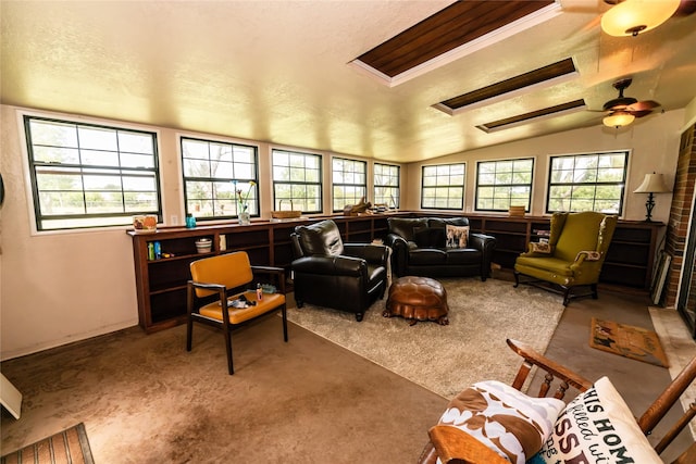 carpeted living room featuring vaulted ceiling and ceiling fan