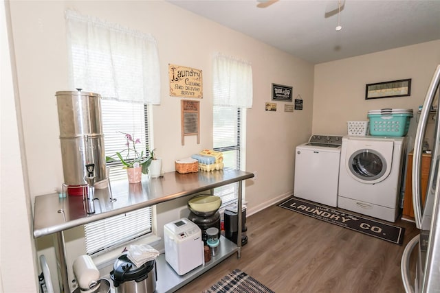 clothes washing area with ceiling fan, independent washer and dryer, and hardwood / wood-style floors