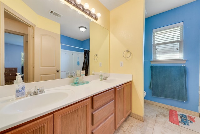 bathroom with tile patterned floors, vanity, curtained shower, and toilet