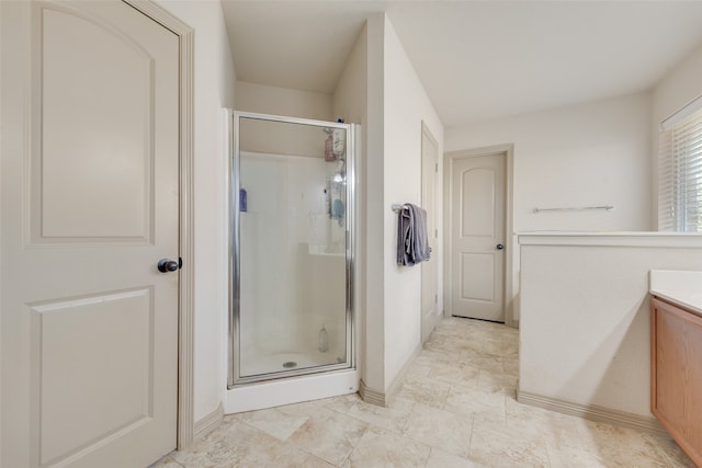 bathroom with vanity and a shower with door