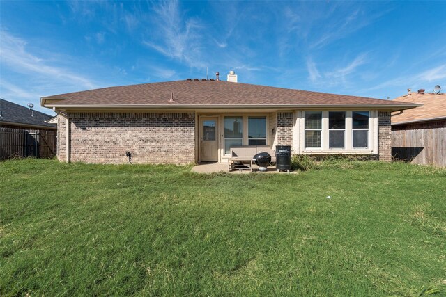 rear view of house with a yard