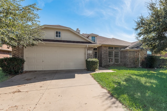 view of front of property with a front yard and a garage