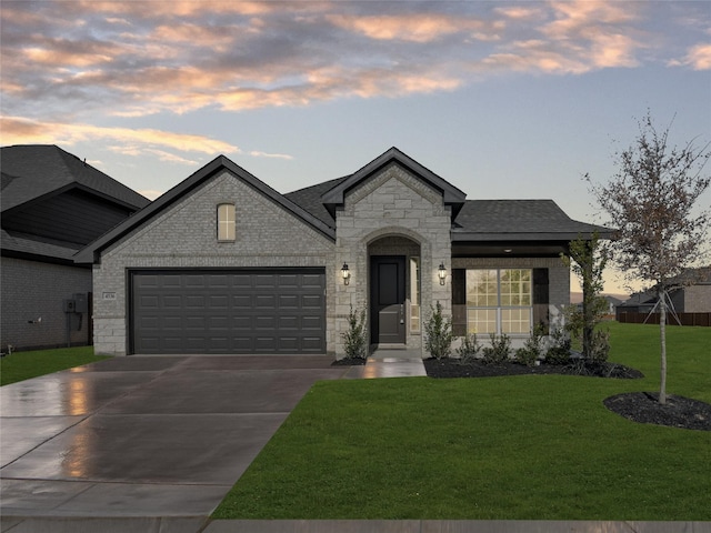 french country inspired facade with a garage and a lawn