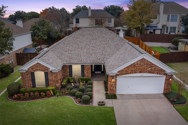 view of front of home featuring a yard and a garage