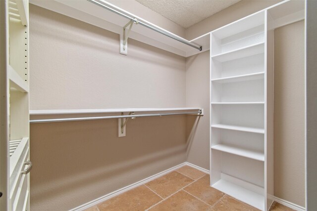 walk in closet with tile patterned flooring