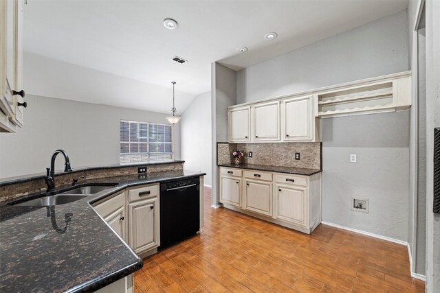 4721 Layla Rd, Arlington, TX 76016 - kitchen with black dishwasher, a sink, tasteful backsplash, light wood-style flooring, and vaulted ceiling