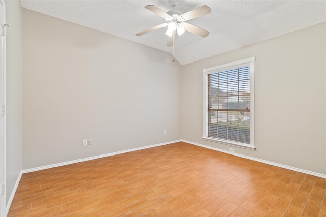 4721 Layla Rd, Arlington, TX 76016 - unfurnished room featuring light wood-style flooring, baseboards, ceiling fan, a textured ceiling, and lofted ceiling