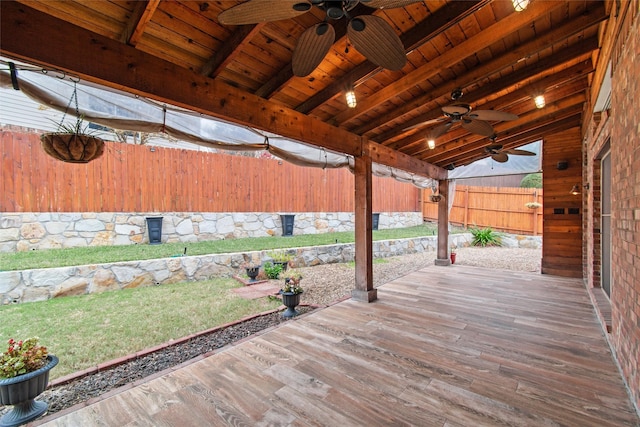 wooden terrace featuring a yard and ceiling fan