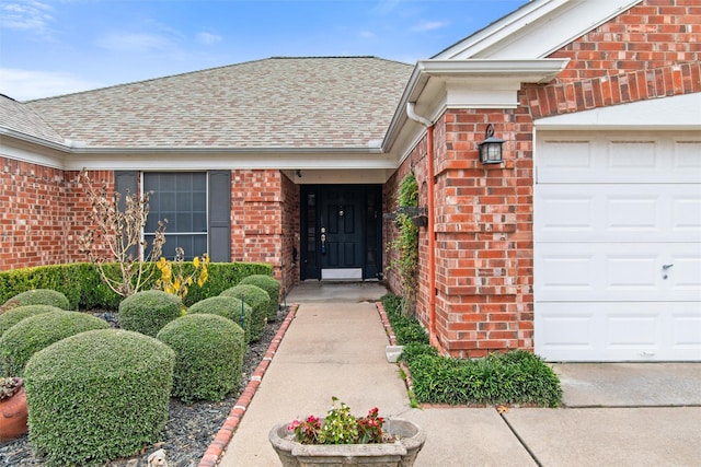 4721 Layla Rd, Arlington, TX 76016 - view of exterior entry with brick siding, a shingled roof, and a garage