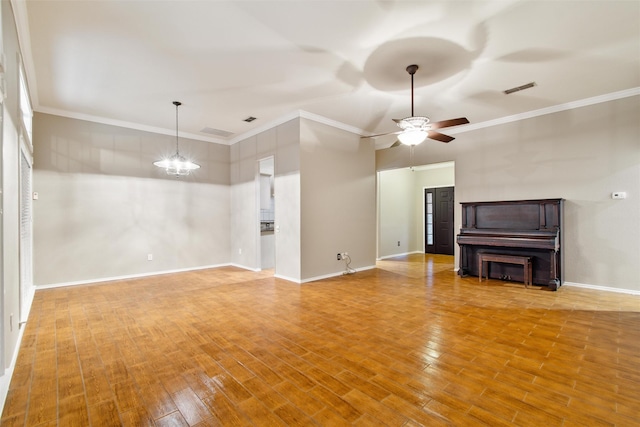 unfurnished living room featuring ceiling fan with notable chandelier, light hardwood / wood-style floors, and ornamental molding