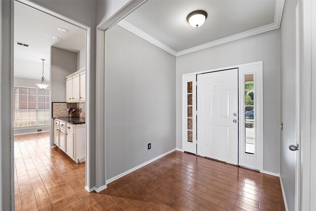 4721 Layla Rd, Arlington, TX 76016 - entryway with healthy amount of natural light, ornamental molding, wood finished floors, and baseboards