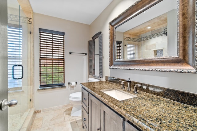 bathroom with vanity, toilet, and walk in shower