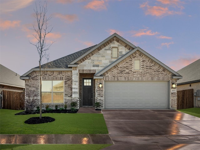 view of front facade featuring a garage and a lawn