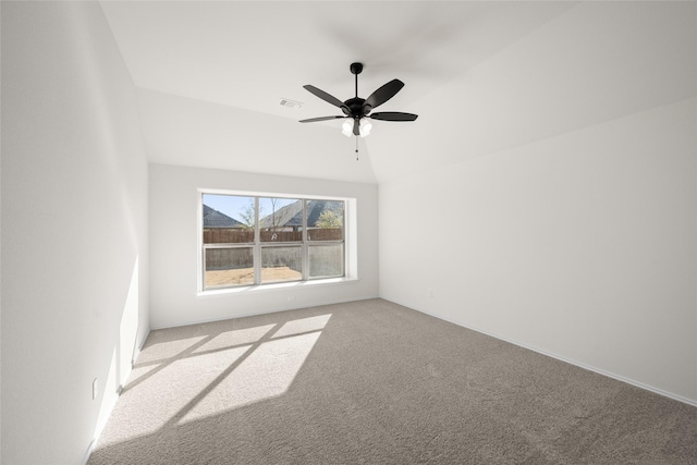 carpeted empty room with vaulted ceiling and ceiling fan