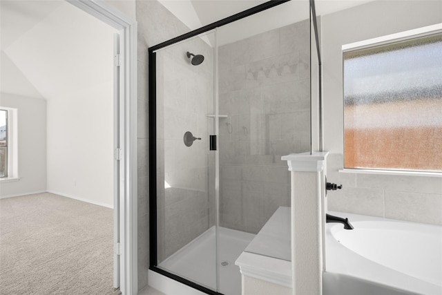 bathroom featuring independent shower and bath and lofted ceiling