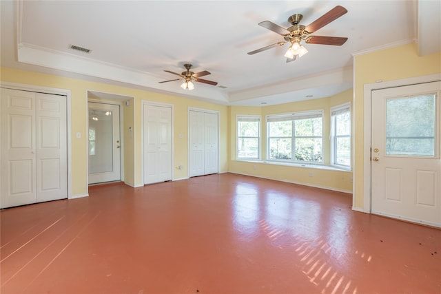 unfurnished living room featuring a raised ceiling, ornamental molding, and ceiling fan