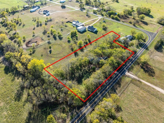 birds eye view of property with a rural view