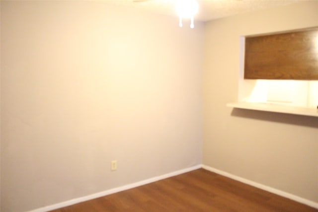 unfurnished room with hardwood / wood-style floors