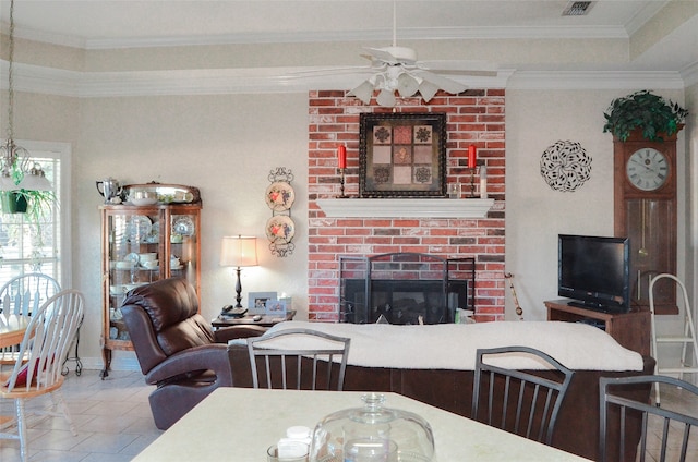 dining area with ceiling fan, tile patterned floors, ornamental molding, and a fireplace