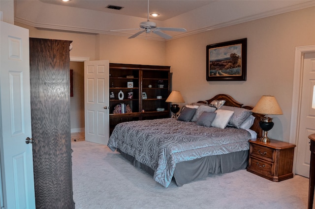 carpeted bedroom with ornamental molding and ceiling fan