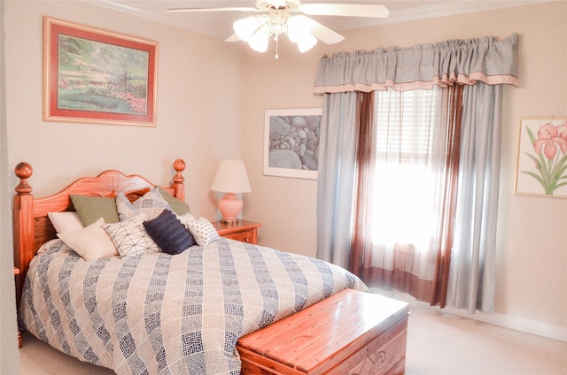 carpeted bedroom featuring ornamental molding and ceiling fan