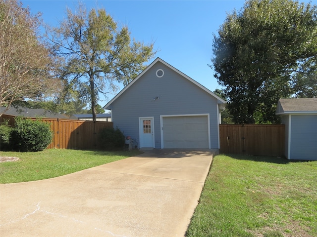 view of side of home with an outbuilding, a garage, and a yard