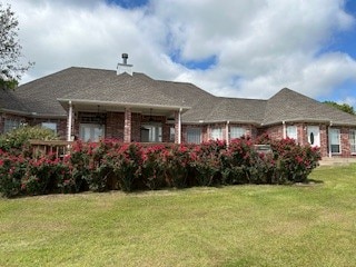 back of house with a yard