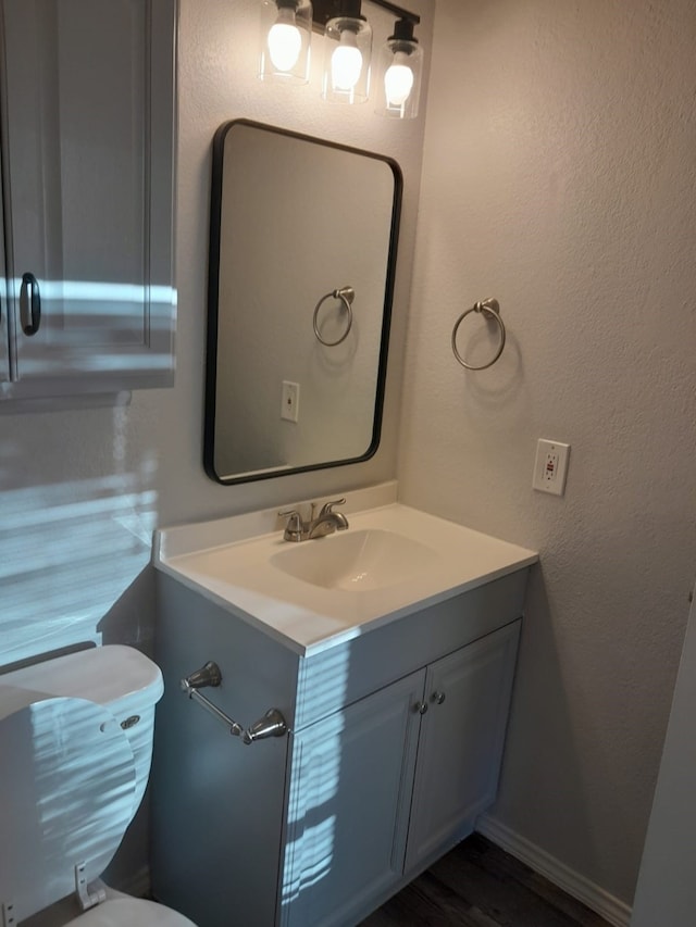 bathroom with vanity and hardwood / wood-style flooring