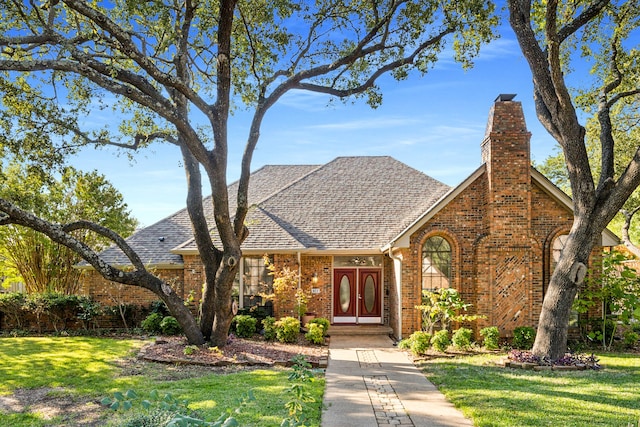 tudor home featuring a front lawn