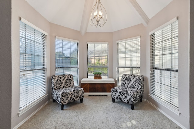 sitting room with a healthy amount of sunlight, carpet flooring, vaulted ceiling with beams, and a notable chandelier