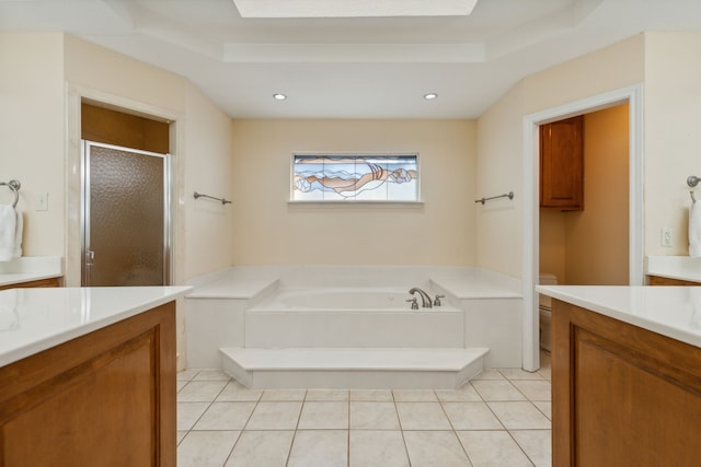 full bathroom featuring a raised ceiling, vanity, and tile patterned floors