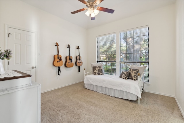 bedroom featuring light colored carpet and ceiling fan