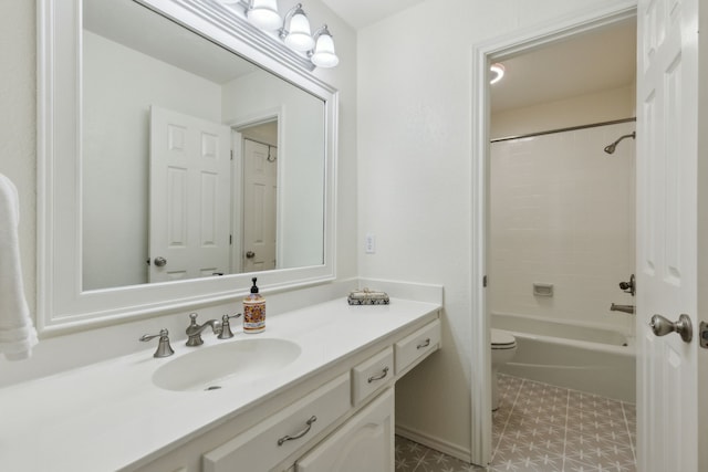 full bathroom featuring tiled shower / bath, vanity, and toilet