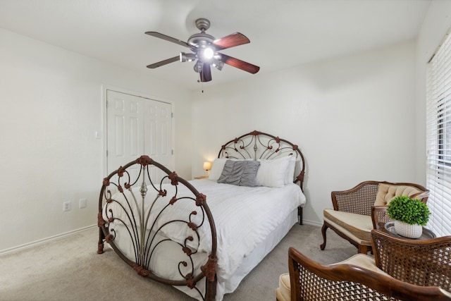 carpeted bedroom with a closet, multiple windows, and ceiling fan