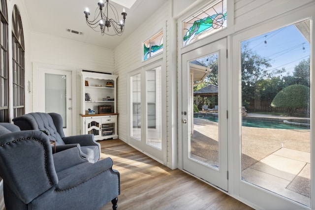 interior space featuring hardwood / wood-style floors and a notable chandelier