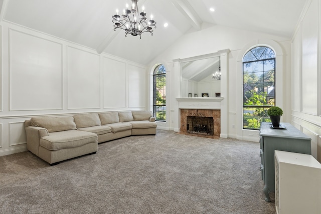 living room featuring beam ceiling, carpet flooring, a healthy amount of sunlight, and a fireplace