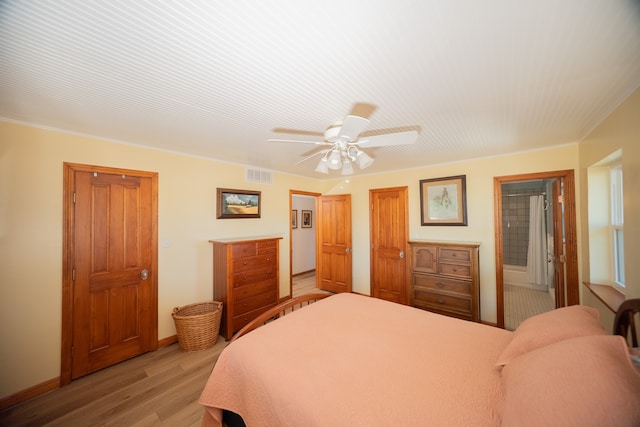 bedroom featuring ornamental molding, light wood-type flooring, and ceiling fan