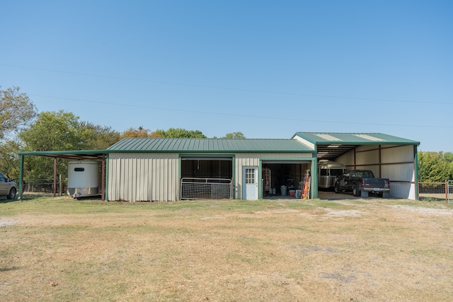 view of outdoor structure featuring a lawn and a carport