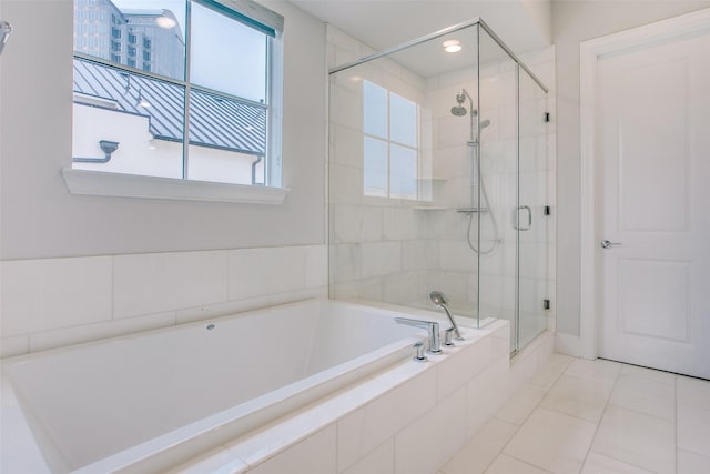 bathroom with tile patterned floors and independent shower and bath