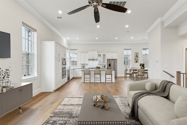 entrance foyer with light hardwood / wood-style flooring and ornamental molding