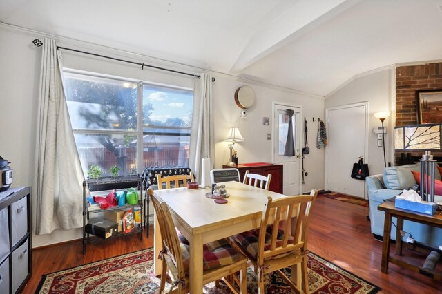 dining room featuring dark wood-type flooring and lofted ceiling