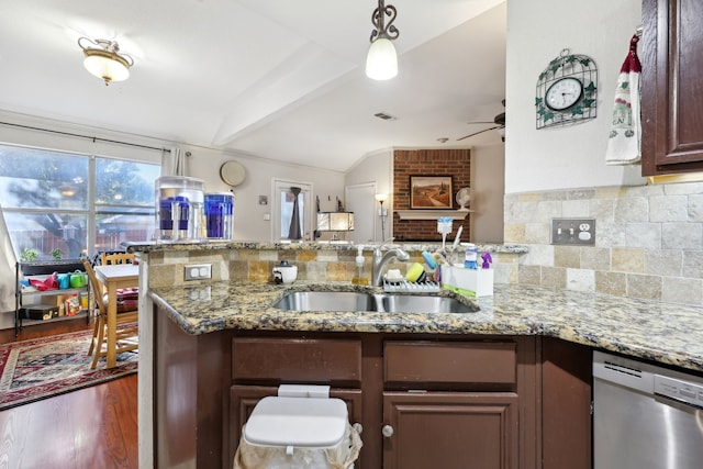 kitchen with sink, light stone counters, ceiling fan, dark hardwood / wood-style floors, and dishwasher