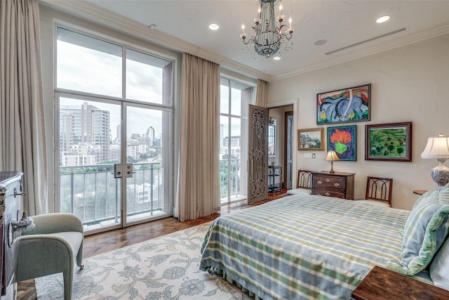 bedroom featuring light hardwood / wood-style floors, access to exterior, an inviting chandelier, and crown molding