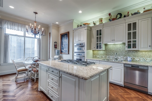 kitchen featuring stainless steel appliances, sink, hanging light fixtures, dark parquet floors, and a kitchen island