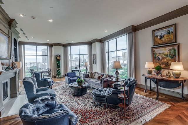 living room with parquet flooring, ornamental molding, and plenty of natural light