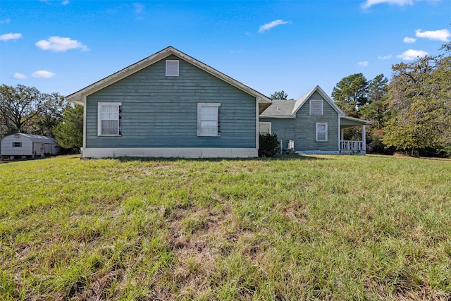 rear view of property featuring a yard