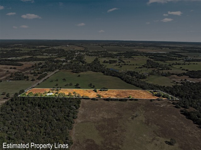 birds eye view of property with a rural view